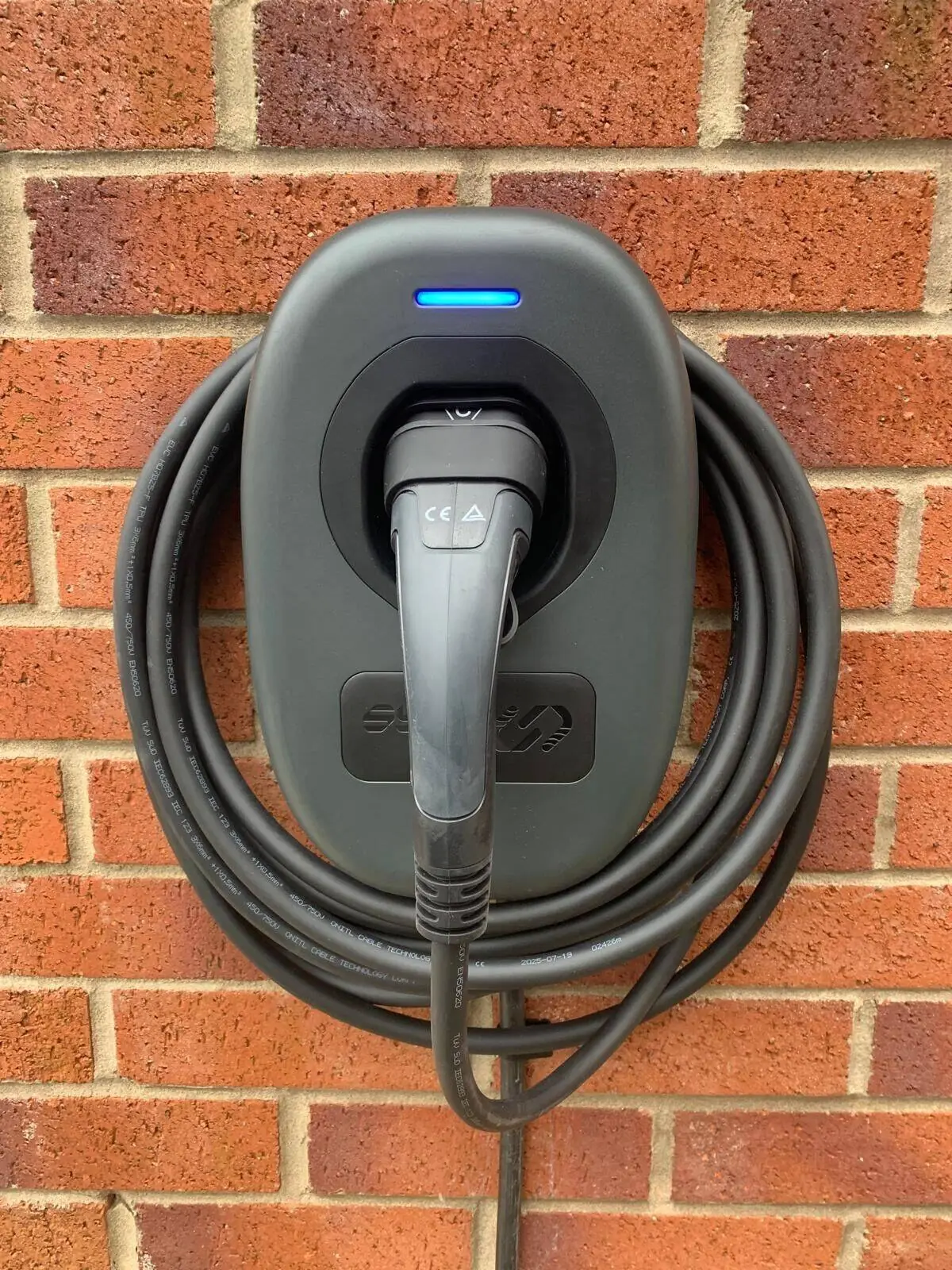 SYNC Energy 7kW EV charger installed on an exterior wall